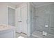 Modern bathroom with a glass-enclosed shower, white vanity, and ample storage at 689 Sunstone Ln, Lawrenceville, GA 30043