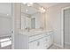 Bathroom with double vanity, undermount sinks, chrome hardware, and a view to the bedroom at 689 Sunstone Ln, Lawrenceville, GA 30043