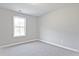 Simple bedroom with carpet flooring and a window offering natural light at 689 Sunstone Ln, Lawrenceville, GA 30043
