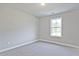 Cozy bedroom with carpet flooring, featuring a window that offers natural light at 689 Sunstone Ln, Lawrenceville, GA 30043