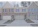 New construction townhome showcasing a brick and siding exterior with attached two-car garage at 689 Sunstone Ln, Lawrenceville, GA 30043