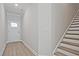 Bright foyer with hardwood floors, white door, and staircase leading to the upper level at 689 Sunstone Ln, Lawrenceville, GA 30043