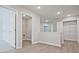 Hallway with luxury vinyl plank flooring, access to laundry room and walk in closets at 689 Sunstone Ln, Lawrenceville, GA 30043