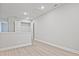 Bright hallway featuring wood-look floors, white trim, and a closet with shelving for ample storage at 689 Sunstone Ln, Lawrenceville, GA 30043