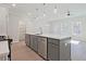 Open kitchen with gray cabinets, quartz countertops, stainless steel appliances, and pendant lighting at 689 Sunstone Ln, Lawrenceville, GA 30043