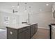 Kitchen island with stainless steel sink, modern faucet, and pendant lighting at 689 Sunstone Ln, Lawrenceville, GA 30043