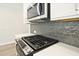 Stainless steel microwave and range with gray subway tile backsplash at 689 Sunstone Ln, Lawrenceville, GA 30043