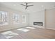 Open-concept living room featuring large windows and a modern fireplace at 689 Sunstone Ln, Lawrenceville, GA 30043