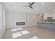Open-concept living room with modern fireplace and kitchen with island at 689 Sunstone Ln, Lawrenceville, GA 30043