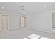 Spacious main bedroom with carpet flooring, ensuite access, and ample natural light at 689 Sunstone Ln, Lawrenceville, GA 30043
