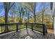 Deck overlooking a wooded backyard with a grassy area at 1382 Almont Sw Dr, Atlanta, GA 30310