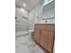 Modern bathroom with marble shower and wood vanity at 1382 Almont Sw Dr, Atlanta, GA 30310