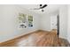 Bright bedroom featuring hardwood floors and ceiling fan at 1382 Almont Sw Dr, Atlanta, GA 30310