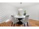 Modern dining room with white accent wall and hardwood floors at 1382 Almont Sw Dr, Atlanta, GA 30310