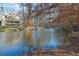 Lake view from wooded area, autumn leaves abound at 6740 Mountain Lake Ln, Cumming, GA 30028