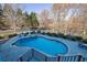 Inviting kidney-shaped pool with a stone patio and water feature at 6740 Mountain Lake Ln, Cumming, GA 30028