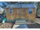 Wooden storage shed with double doors and windows at 6740 Mountain Lake Ln, Cumming, GA 30028