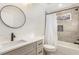 Well-lit bathroom with a modern vanity, bathtub, and shower combo at 241 Hembree Drive, Canton, GA 30115
