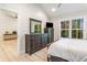 Bedroom with a view, featuring an elegant dresser, a mirror, and natural light at 241 Hembree Drive, Canton, GA 30115