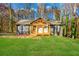 Charming gray home featuring a new front porch and lush green lawn surrounded by fall foliage at 241 Hembree Drive, Canton, GA 30115