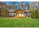 Charming gray home featuring a new front porch and lush green lawn surrounded by fall foliage at 241 Hembree Drive, Canton, GA 30115