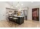 Modern kitchen island with barstool seating, stainless refrigerator, and a pantry with barn door access at 241 Hembree Drive, Canton, GA 30115