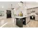 Bright kitchen with gray cabinets, modern lighting, island seating, and an adjacent fireplace living room at 241 Hembree Drive, Canton, GA 30115