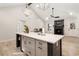 Open kitchen with a large island, marble countertops, modern lighting, and a cozy fireplace at 241 Hembree Drive, Canton, GA 30115