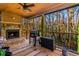 Relaxing screened porch with fireplace and wooded views at 241 Hembree Drive, Canton, GA 30115