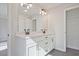 Bathroom featuring double vanity with a large mirror and closet at 687 Sunstone Ln, Lawrenceville, GA 30043