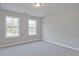 Bright bedroom with neutral gray walls and plush carpet, illuminated by natural light from the windows at 687 Sunstone Ln, Lawrenceville, GA 30043