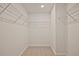 Walk-in closet with ample shelving and carpet floors at 687 Sunstone Ln, Lawrenceville, GA 30043
