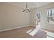 Cozy dining area with modern chandelier, wood floors, and natural light at 687 Sunstone Ln, Lawrenceville, GA 30043