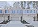 Charming townhome with a mix of brick and siding, featuring a two-car garage and landscaped front yard at 687 Sunstone Ln, Lawrenceville, GA 30043