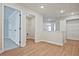 Hallway featuring wood floors, neutral walls, and access to storage and living spaces at 687 Sunstone Ln, Lawrenceville, GA 30043