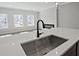 Close up of the kitchen island sink featuring a modern faucet, sink and countertop at 687 Sunstone Ln, Lawrenceville, GA 30043