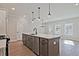 Kitchen island with modern faucet and sink, stainless dishwasher, and quartz countertop at 687 Sunstone Ln, Lawrenceville, GA 30043