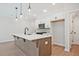 New kitchen showcases a large island, stainless appliances, and white cabinetry at 687 Sunstone Ln, Lawrenceville, GA 30043