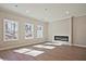Bright living room featuring hardwood floors, large windows, neutral color scheme, and cozy fireplace at 687 Sunstone Ln, Lawrenceville, GA 30043