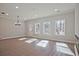 Bright living room featuring hardwood floors, large windows, modern lighting and neutral color scheme at 687 Sunstone Ln, Lawrenceville, GA 30043