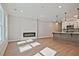 Open living space with modern fireplace and kitchen featuring an island with pendant lighting at 687 Sunstone Ln, Lawrenceville, GA 30043