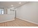 Upstairs hallway featuring wood floors, neutral walls, and storage access at 687 Sunstone Ln, Lawrenceville, GA 30043