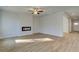 Living room with fireplace, ceiling fan and wood-look floors at 113 Belvedere Rd, Mcdonough, GA 30253