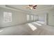 Sunlit main bedroom with carpet, high ceilings, and multiple windows at 113 Belvedere Rd, Mcdonough, GA 30253