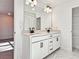 Contemporary bathroom with double sink vanity, stylish black fixtures, and marble floors at 685 Sunstone Ln, Lawrenceville, GA 30043