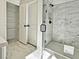 Modern bathroom featuring a glass-enclosed shower and marble tile at 685 Sunstone Ln, Lawrenceville, GA 30043