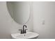 Bathroom features a modern sink, faucet, and oval mirror at 685 Sunstone Ln, Lawrenceville, GA 30043