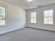 Bedroom with carpet and three windows providing lots of natural light at 685 Sunstone Ln, Lawrenceville, GA 30043