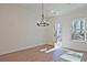 Cozy dining area with a stylish chandelier and access to the backyard at 685 Sunstone Ln, Lawrenceville, GA 30043