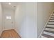 Inviting entryway featuring hardwood floors, a white door, and staircase at 685 Sunstone Ln, Lawrenceville, GA 30043